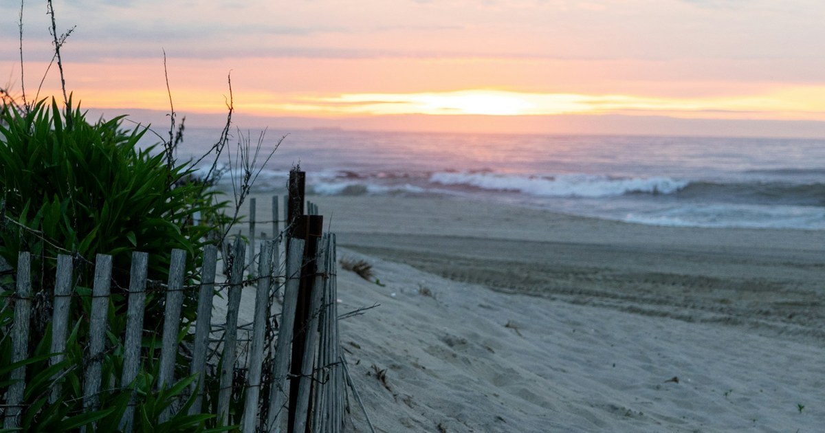 Beach fence and dunes at sunset on the Jersey Shore, illustrating the best time to sell a house in Point Pleasant Beach, NJ